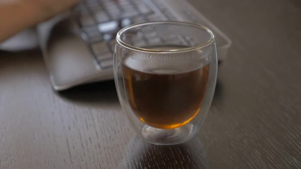 Tea tasting  after  finishing job slow motion 1080p FullHD footage - Panning on glass of tea taking 