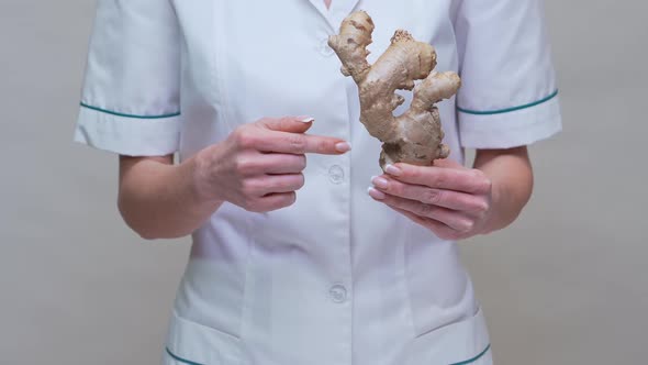 Nutritionist Doctor Healthy Lifestyle Concept - Holding Ginger Root and Medicine or Vitamine Pill