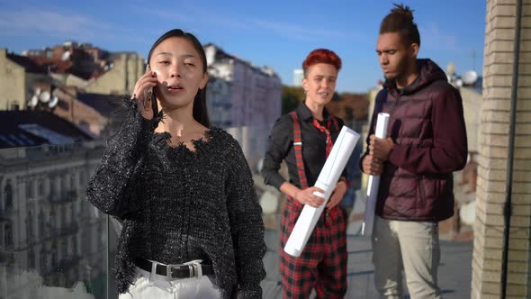 Portrait of Beautiful Asian Young Woman Laughing Talking on Phone in Slow Motion with Blurred