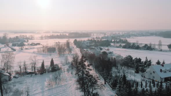 Aerial View of the Road Through the Forest Covered in Snow