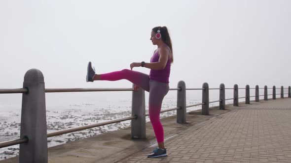 Caucasian woman stretching on the docks