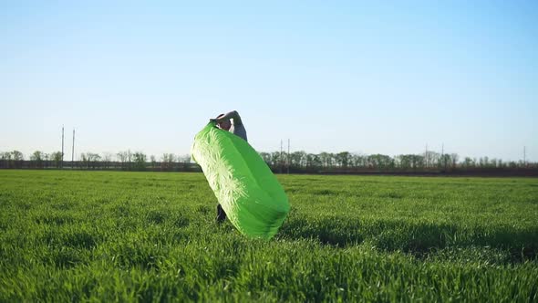 A Man is Trying to Catch the Wind to Make Inflatable Bed