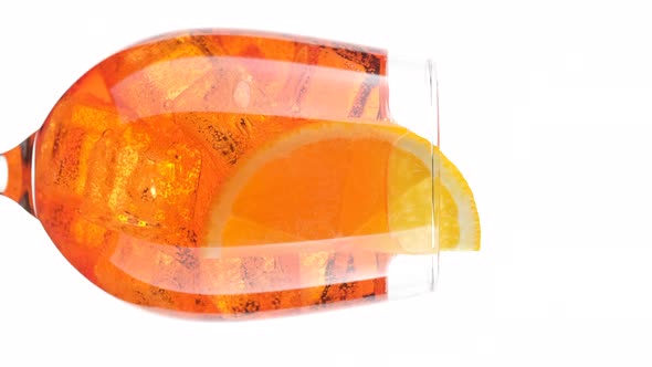 Aperol Spritz Cocktail with ice isolated on white background, rotation.
