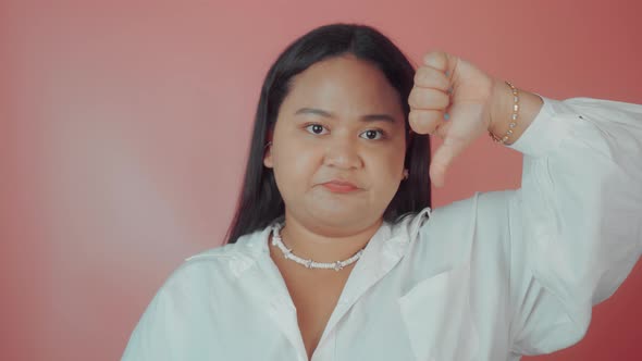 Portrait of an Asian Plus Size Woman with Thumbs Down
