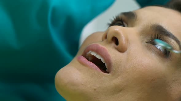 Close-Up Dentist Removing Caries From Teeth of Female, Professional Equipment