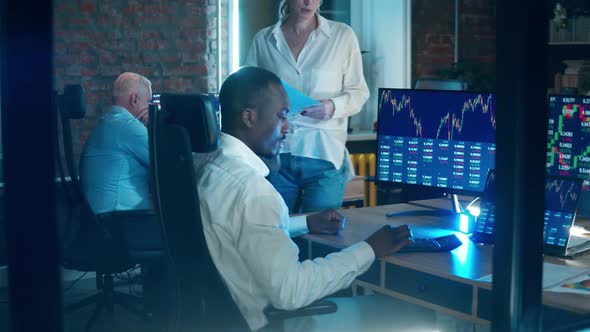 A Group of Traders Working with the Stock Data in the Office