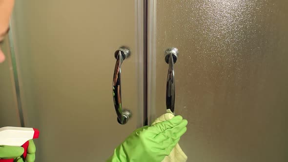 Closeup of a Girl Cleaning a Shower Door
