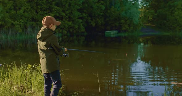 Happy Little Fisher is Pulling Fish From Lake in Summer Morning Hooking and Rejoicing  Prores