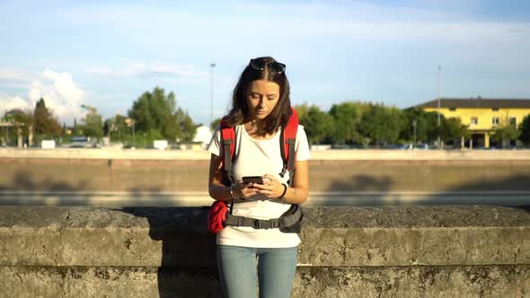 Portrait of female tourist with mobile phone