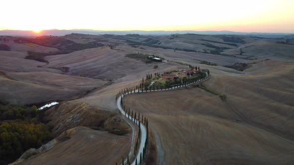 Crete Senesi Tuscan Rolling Hills, Farmhouse, and Cypress Road Aerial View in Tuscany