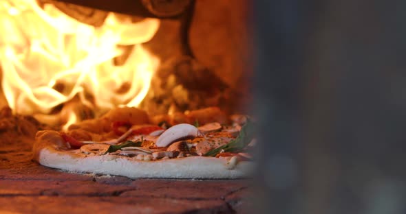 Traditional pizza in oven with flame