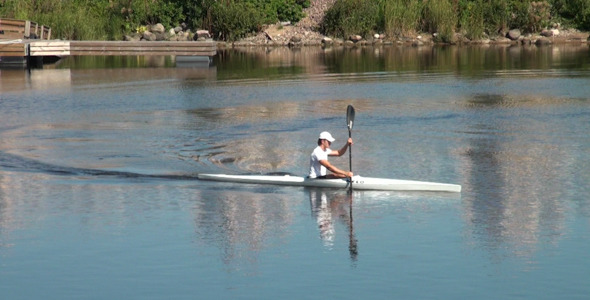 A Man Swims on a Kayak 1