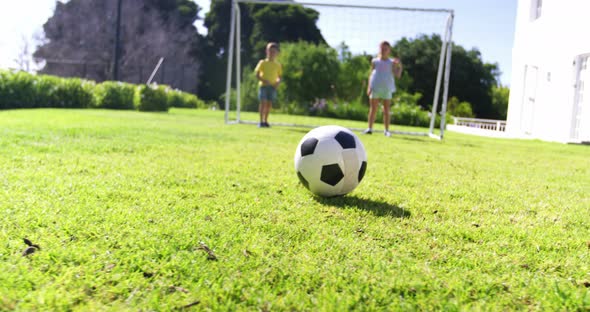 Father and kids playing football