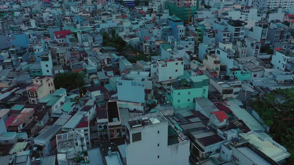 Early morning drone fly in over modern urban rooftops. The city is asleep