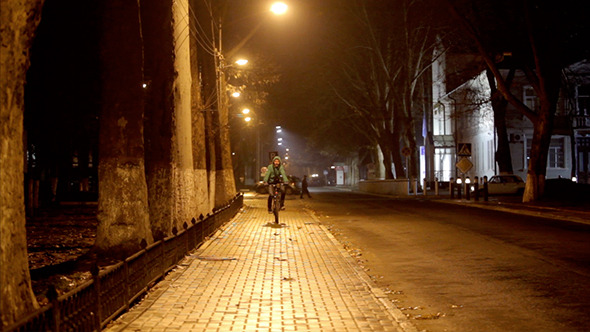 Men Ridding A Bicycle In Night