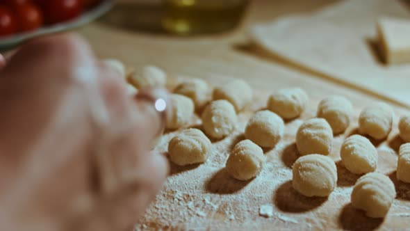 Chef Cutting Rolls of Potato Dough for the Preparation of Homemade Gnocchi Pleasant Atmosphere