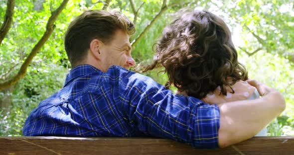 Romantic couple sitting on bench in park