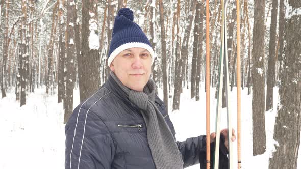 Senior in Winter on Snow with Skis