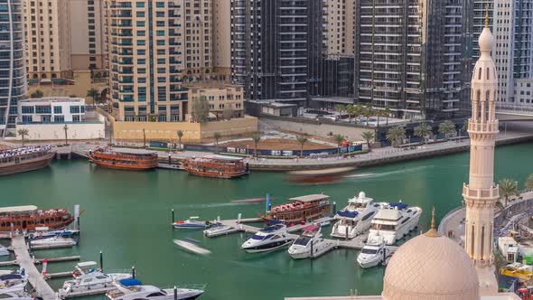 Yachts in Dubai Marina Flanked By the Al Rahim Mosque and Residential Towers and Skyscrapers Aerial