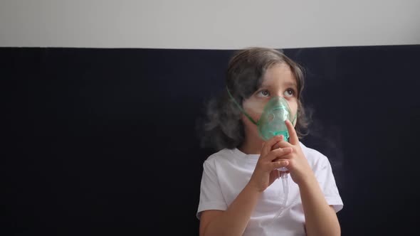 Boy Child Breathes Inhalation Through a Mask is Treated for Allergies