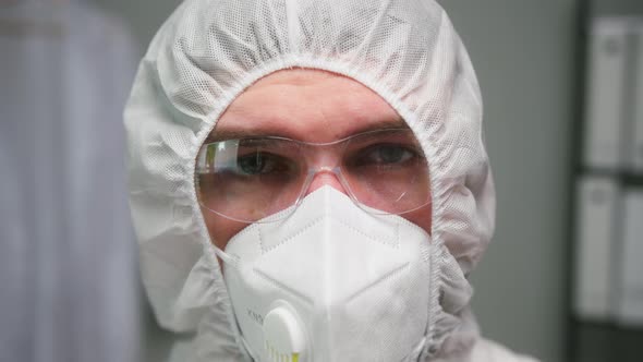 Overworked Doctor or Researcher Dressed in Protective Suit Ppe Mask in Laboratory in Hospital Man alt