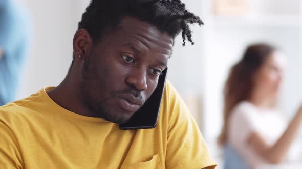 African Businessman Talking on Smartphone in Office