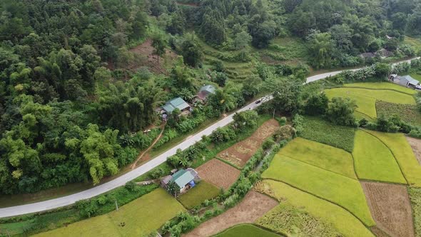 Aerial View of the Road Cars and Motorcycles Are Driving In the Mountains Around the Forest A View