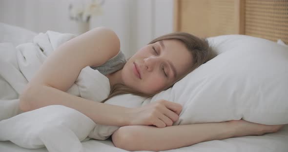 Smiling Woman Waking Up. Teen Hispanic Woman Wakes Up at Home. Young Girl Stretching After Awake