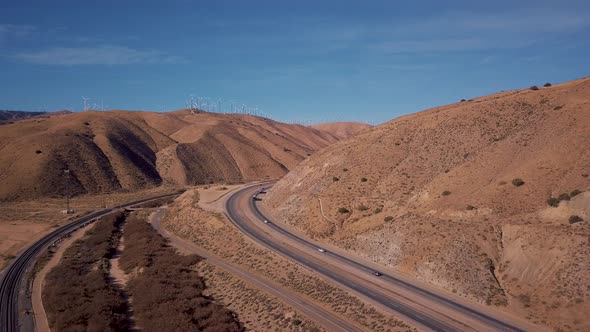 Aerial view of cars and semi trucks driving on scenic state route in California