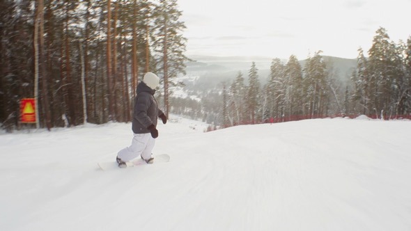 Snowboarder Riding Down the Hill