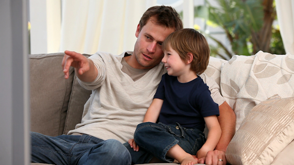 Attentive Father Watching Tv With His Son 