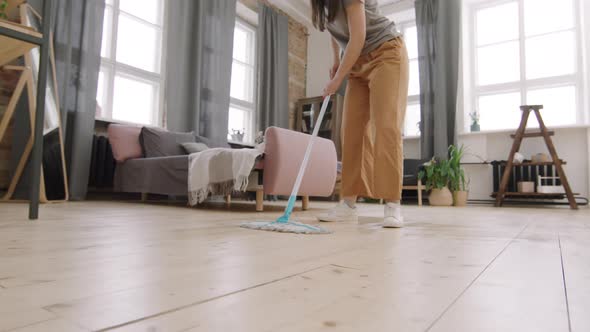 Legs of Woman Mopping Floor and Dancing