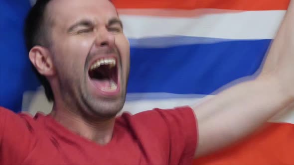 Norwegian Fan Celebrating While Holding the Flag of Norway