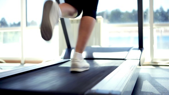 Woman Running on a Treadmill alt