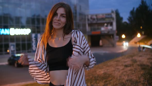 Young Attractive Redhead Hipster Woman Dance on Street at Night