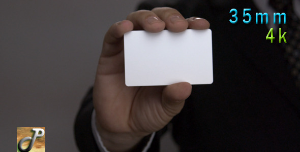 Man Hand Holds Up A Blank Business Card
