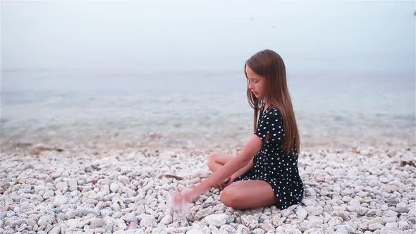 Cute Little Girl at Beach During Summer Vacation