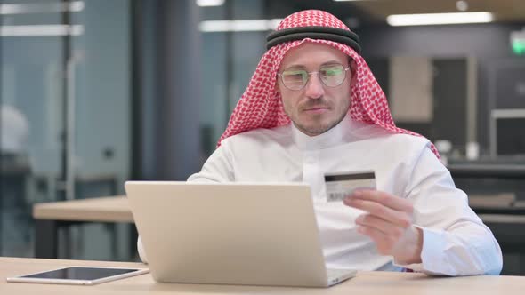 Successful Online Payment on Laptop by Middle Aged Arab Man