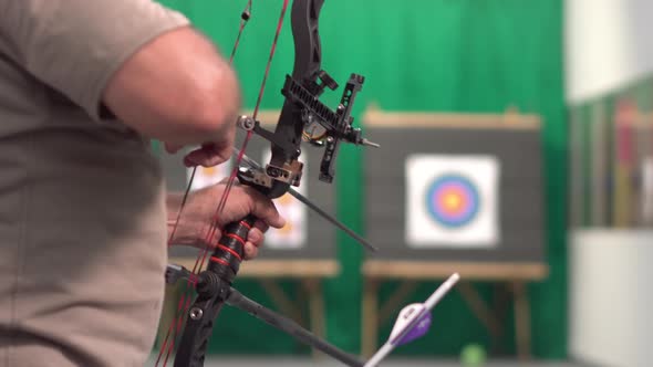 Archer Training With The Bow. Shooting the Target in the Background