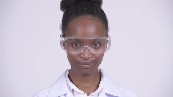 Face of Young Beautiful African Woman Doctor Wearing Protective Glasses