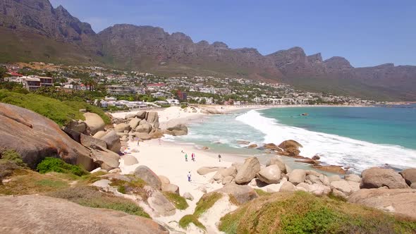Aerial travel drone view of Camps Bay beach, Cape Town, South Africa.