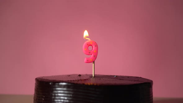 Chocolate Birthday Cake with Wick Lighting Trying to Blowout Candle