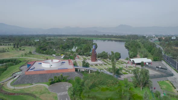 Orbital footage above a lake with view of lake, a highway and a natural area in Xochimilco, Mexico C