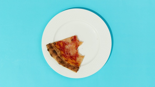 Flat lay Top view Pizza Cut on Plate disappearing on Blue Table - Stop Motion