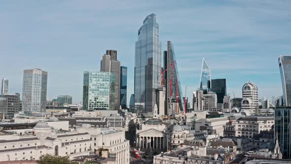 Slow dolly back drone shot from Bank junction and city of London skyscrapers