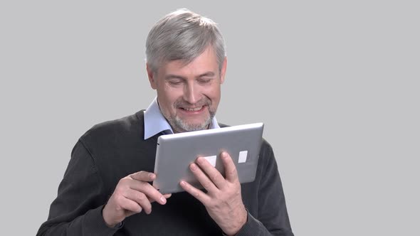 Happy Mature Man Talking Via Pc Tablet.