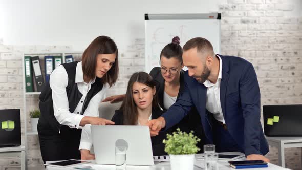 Enthusiastic Business People Discussing Project Showing Presentation to Female Boss Using Laptop