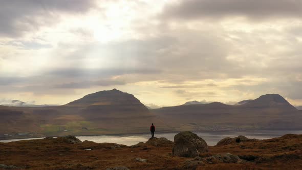 Man Standing In Awe Of Mountains And Landscape