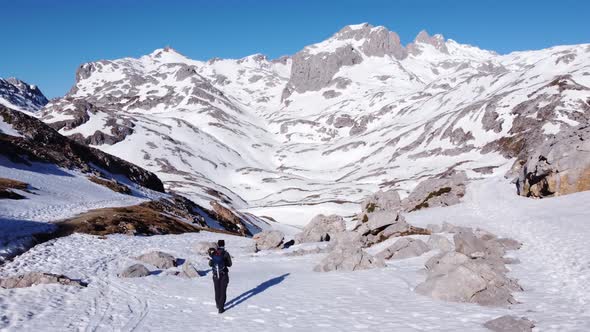 Anonymous travelers walking on Picos de Europa mountains covered with snow