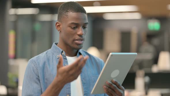 Video Call on Tablet By Young African American Man